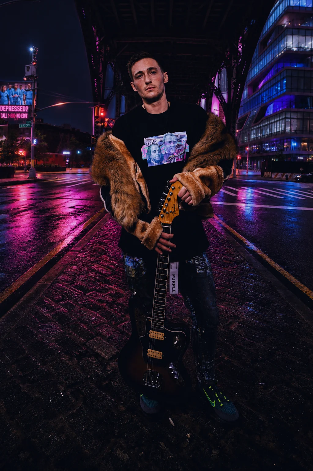 Kaden Quinn holding an electric guitar under a New York bridge at night, lit by pink neon, wearing a fur-trimmed jacket
